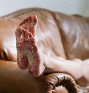 Feet resting on leather sofa