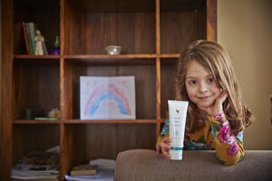 girl holding a tube of aloe gelly